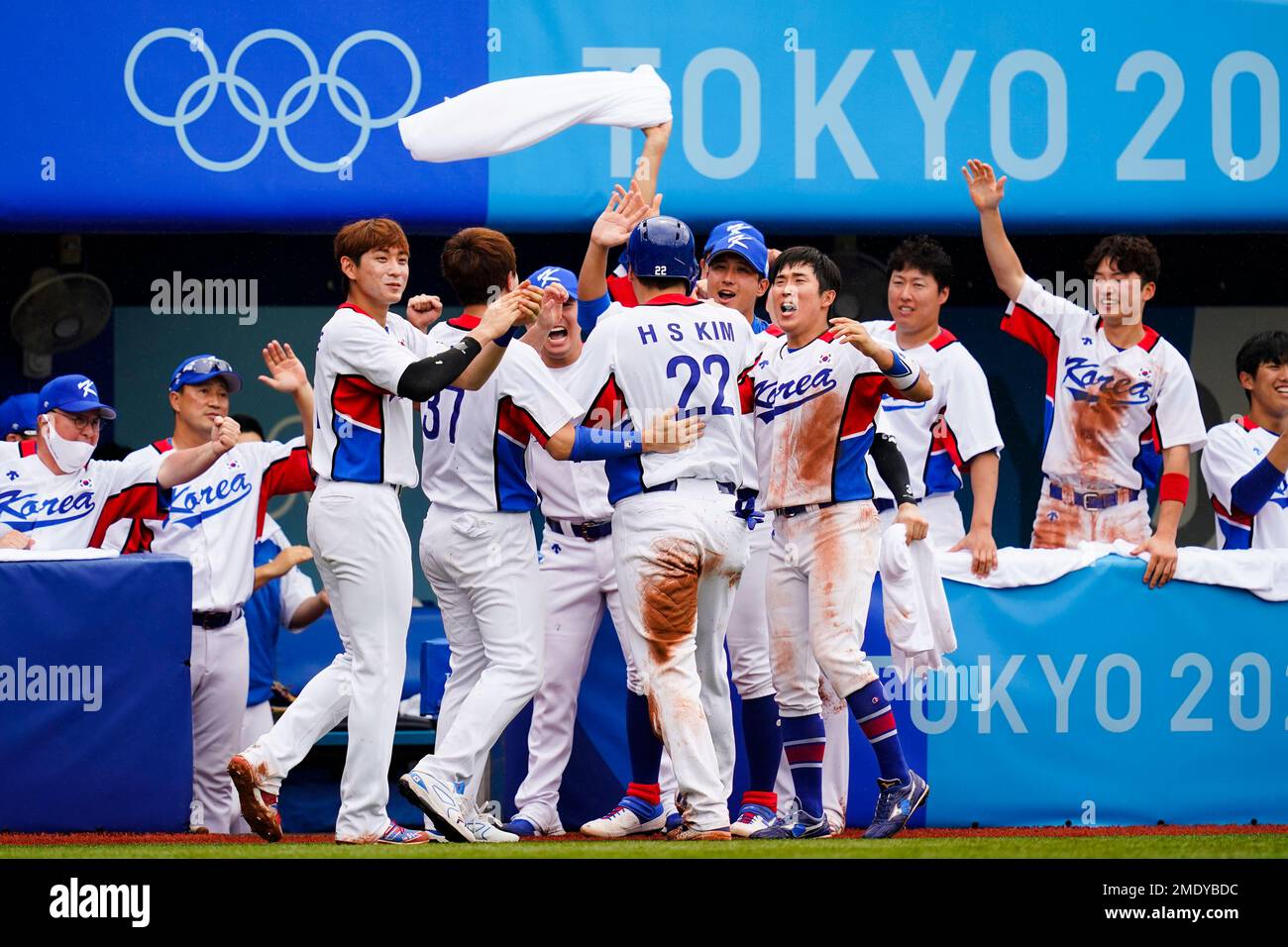 South Korea's Hyunsoo Kim (22) celebrates in the dugout after scoring on a  single by Baekho Kang in the fifth inning of the bronze medal baseball game  against the Dominican Republic at