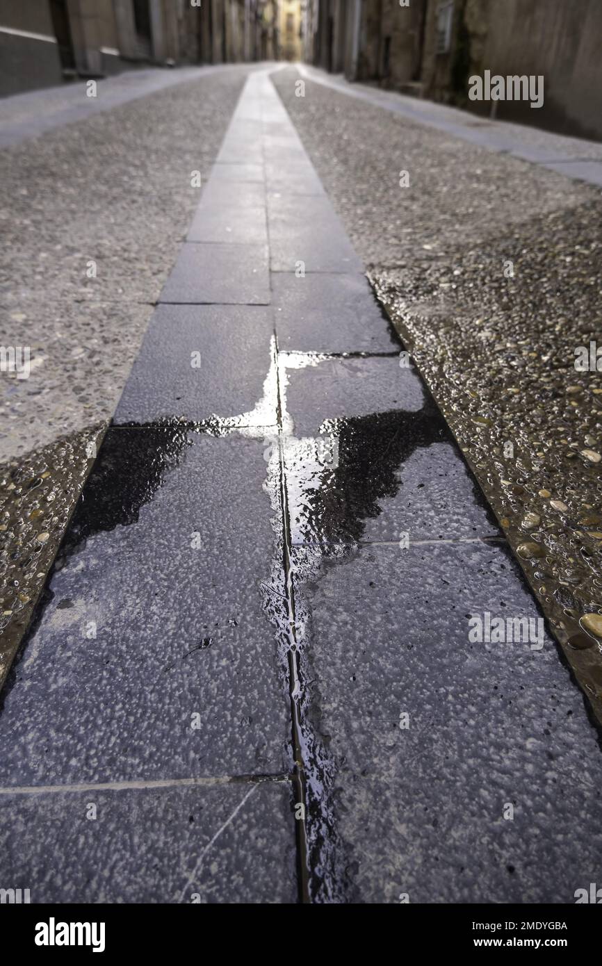 Detail of a wet village street on a rainy day Stock Photo
