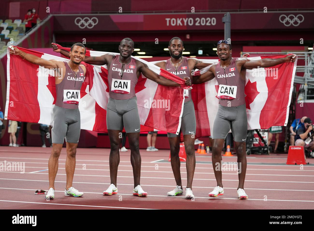 The team from Canada poses after the 4 x100meter relay at the 2020 Summer Olympics, Friday, Aug