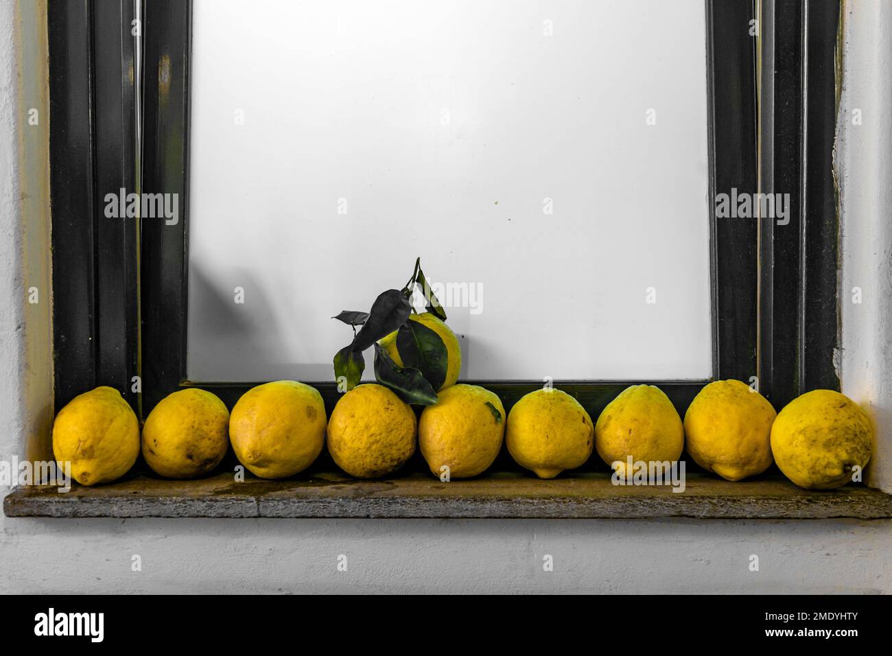 Lemons lined up in a row on a window sill in Capri, Italy. Stock Photo