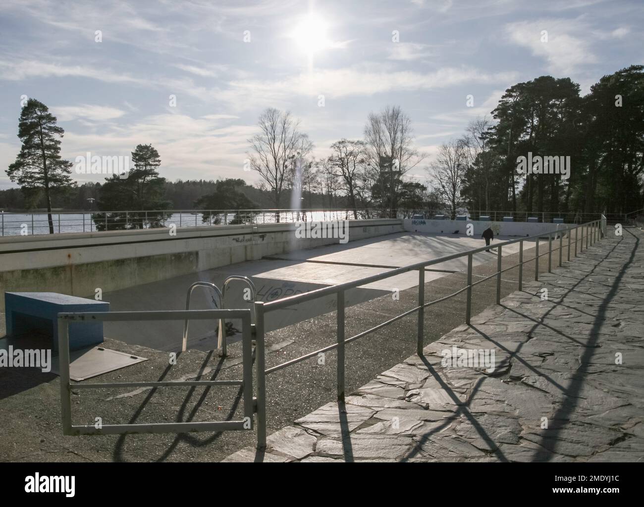 Public swimming pool shot empty in summertime. Old pool represents functionalism and was under a threat of demolition. Stock Photo
