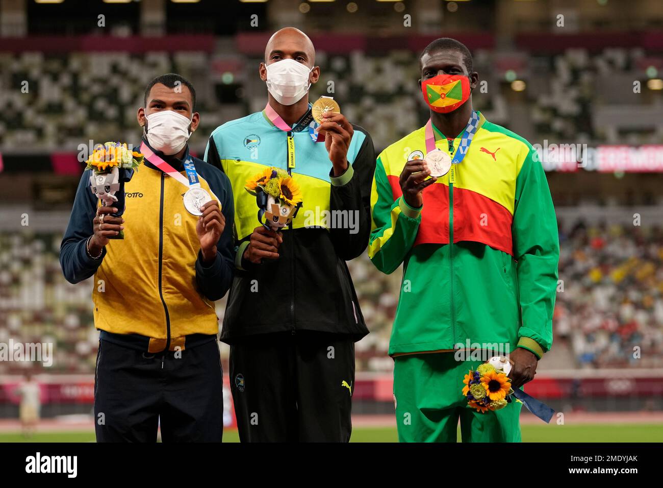 Gold medalist Steven Gardiner, of the Bahamas, center, stands with