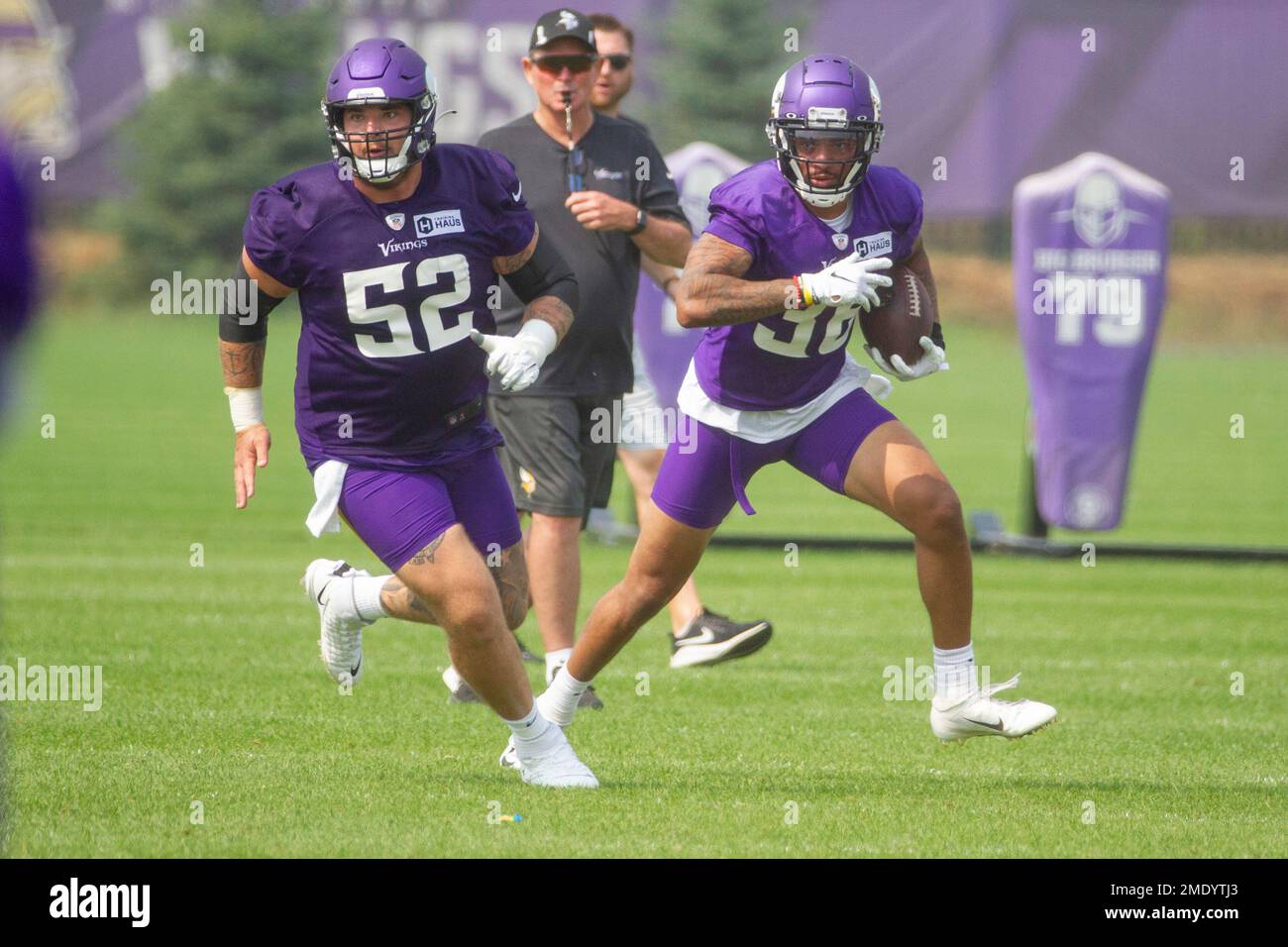 Minnesota Vikings offensive lineman Mason Cole (52) and running