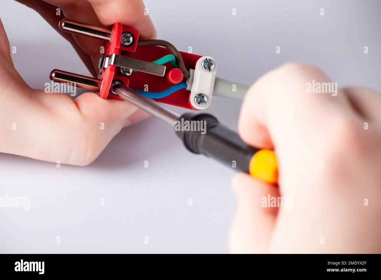 electrician disassembles electric plug. Electric plug with outlet ...