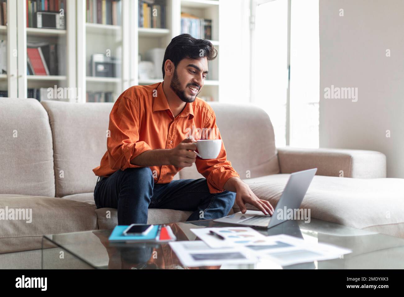 Arab businessman have coffee break while working from home Stock Photo