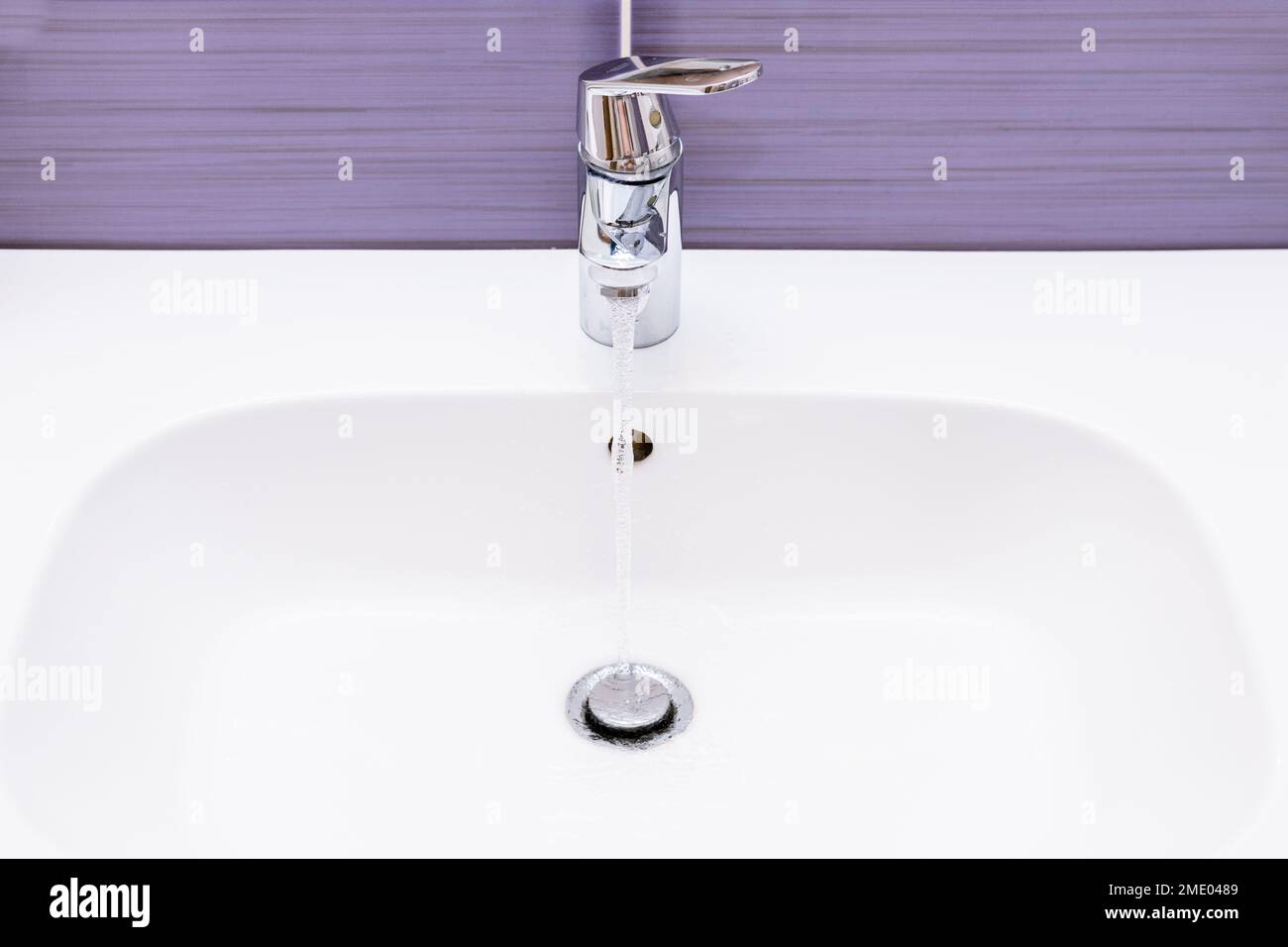 pouring water from the tap in the bathroom, Cost of water consumption