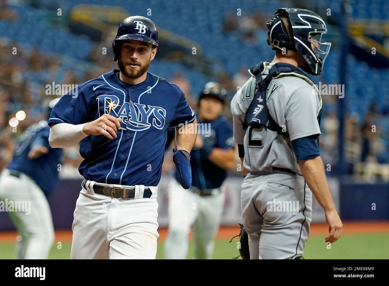 Tampa Bay Rays' Brandon Lowe scores behind Seattle Mariners catcher Tom