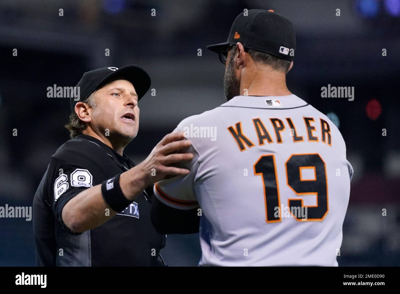 Umpire Chris Guccione, left, explains a call on the field as San Francisco Giants manager Gabe Kapler (19) listens during the eighth inning of a baseball game against the Arizona Diamondbacks, Tuesday, Aug. 3, 2021, in Phoenix. (AP Photo/Ross D. Franklin) Stock Photo