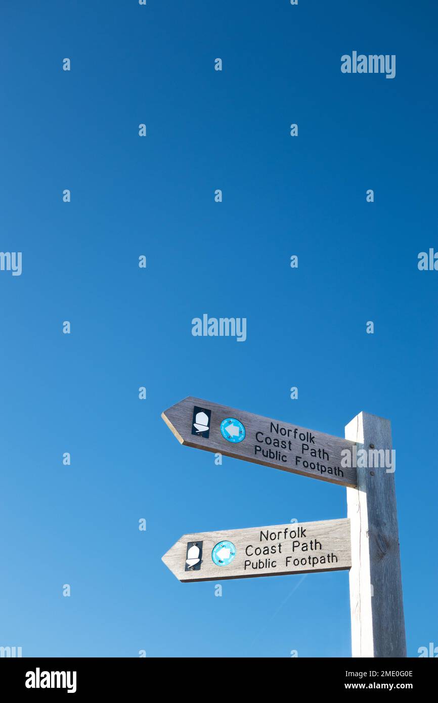 Wooden signpost of Norfolk coastal path agsinst a clear blue sky Stock Photo