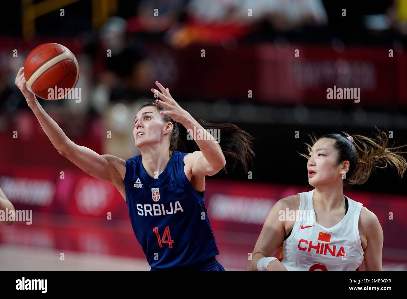 Serbia's Dragana Stankovic (14) drives to the basket ahead of China's Meng  Li, right, during a women's basketball quarterfinal round game at the 2020  Summer Olympics, Wednesday, Aug. 4, 2021, in Saitama,