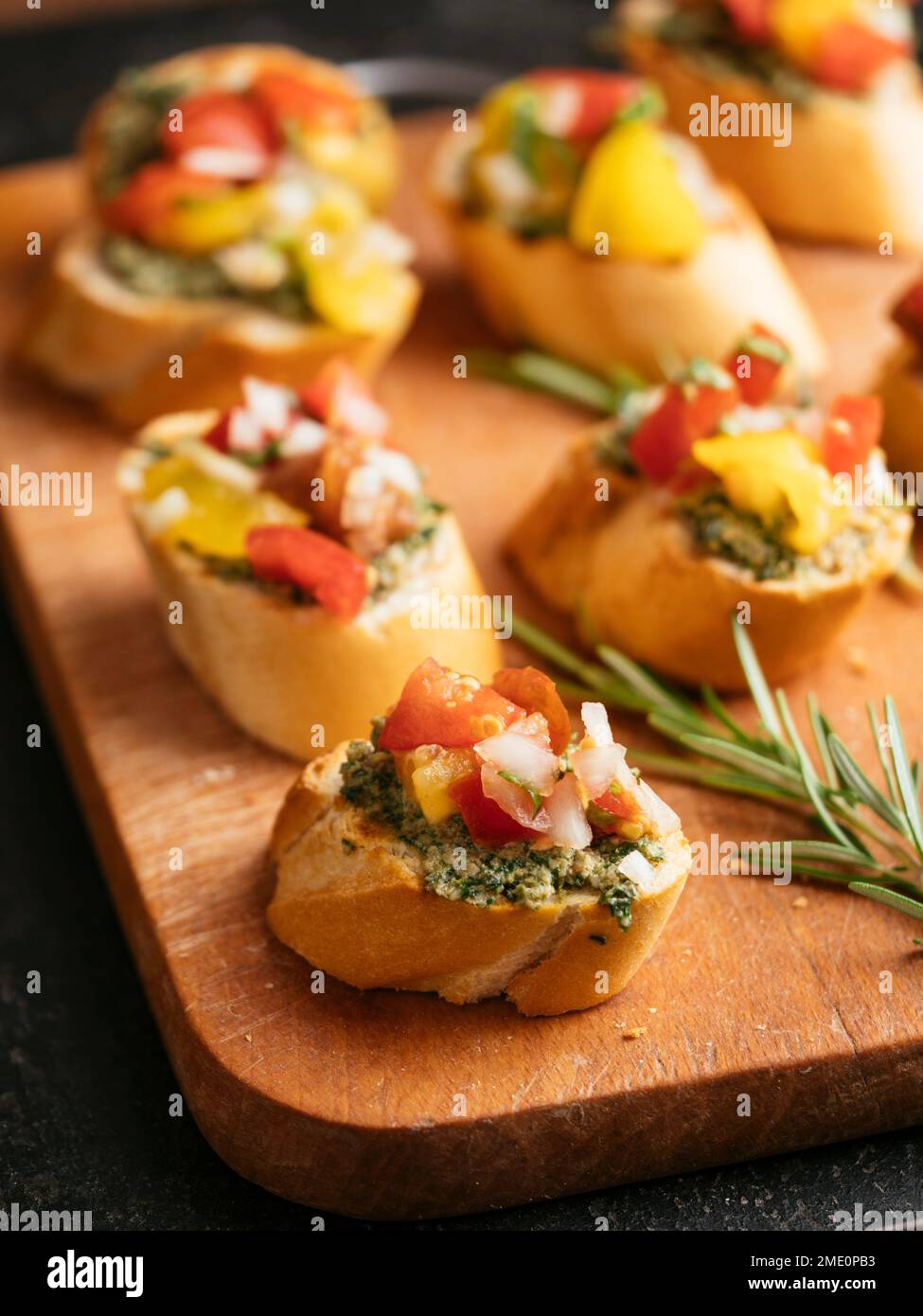 Bruschetta with carrot green pesto and shopped tomatoes. Stock Photo