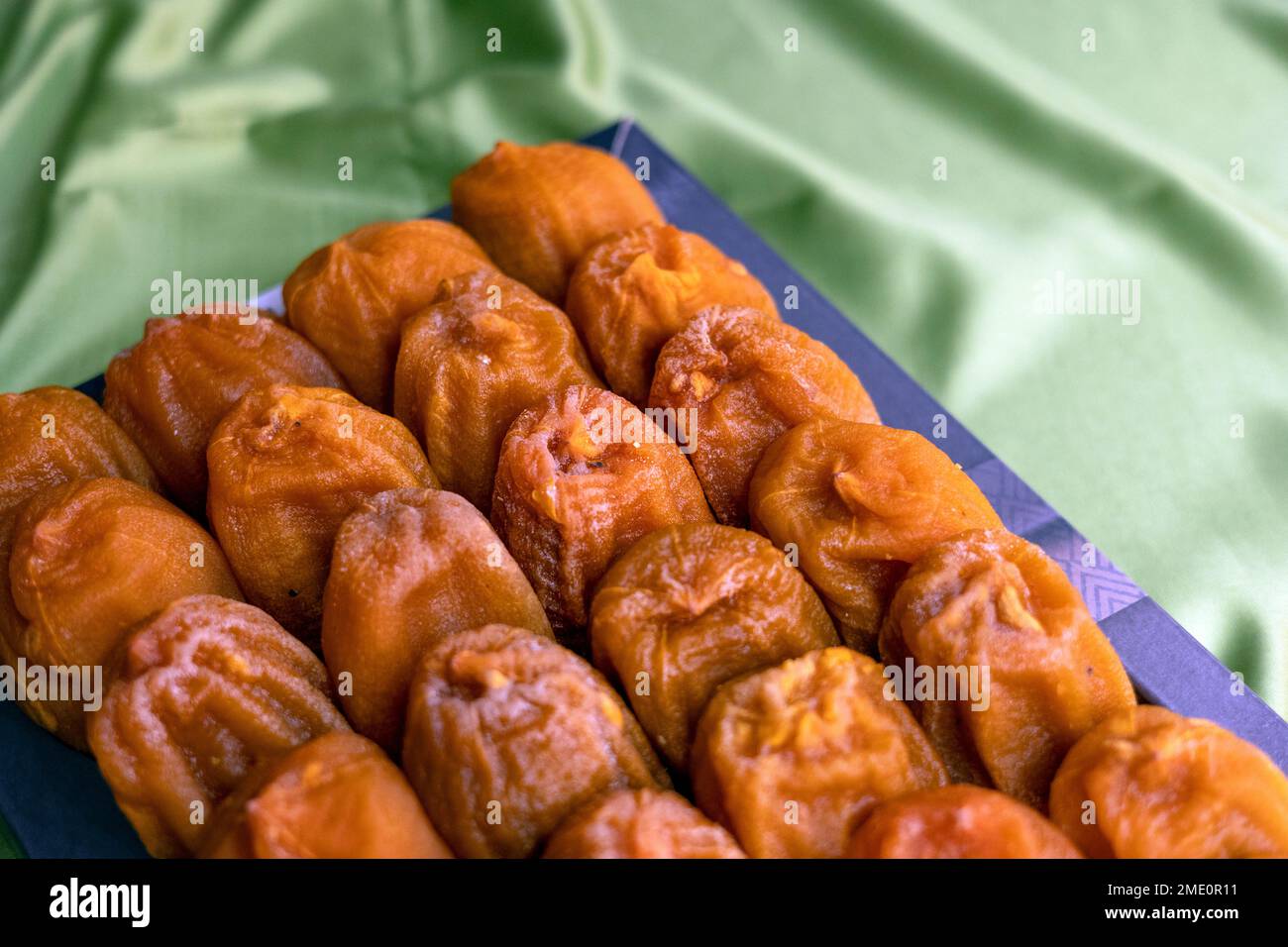 Lots of Dried Persimmon on the green fabric Stock Photo