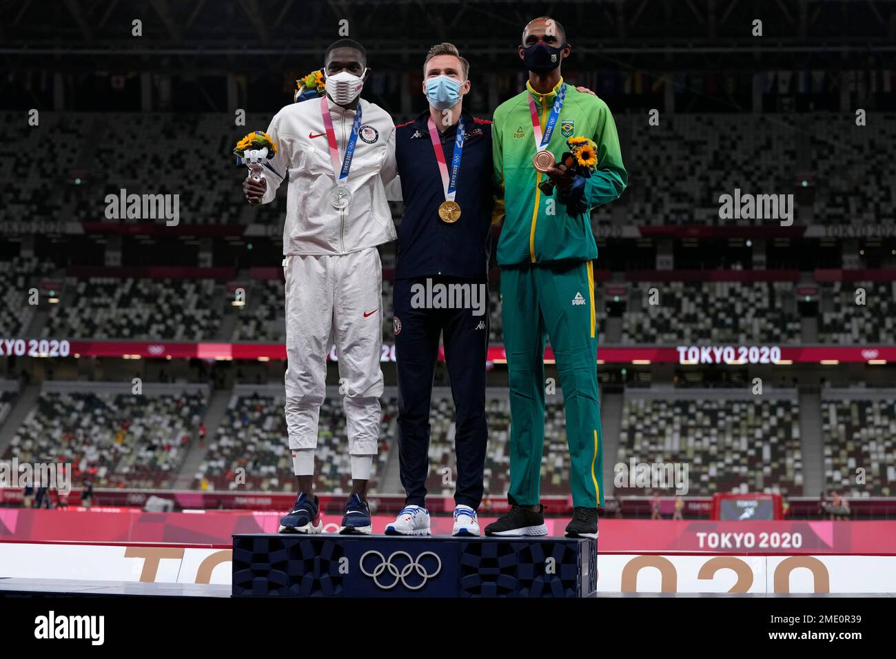 Gold medalist Karsten Warholm, of Norway, centre, stands with silver