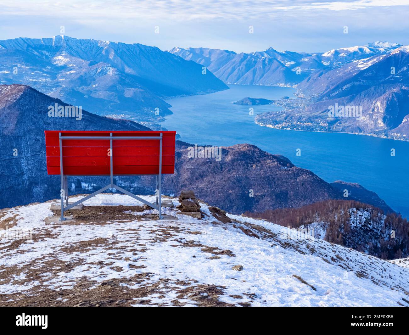 Big red bench on the landscape of Lake Como Stock Photo