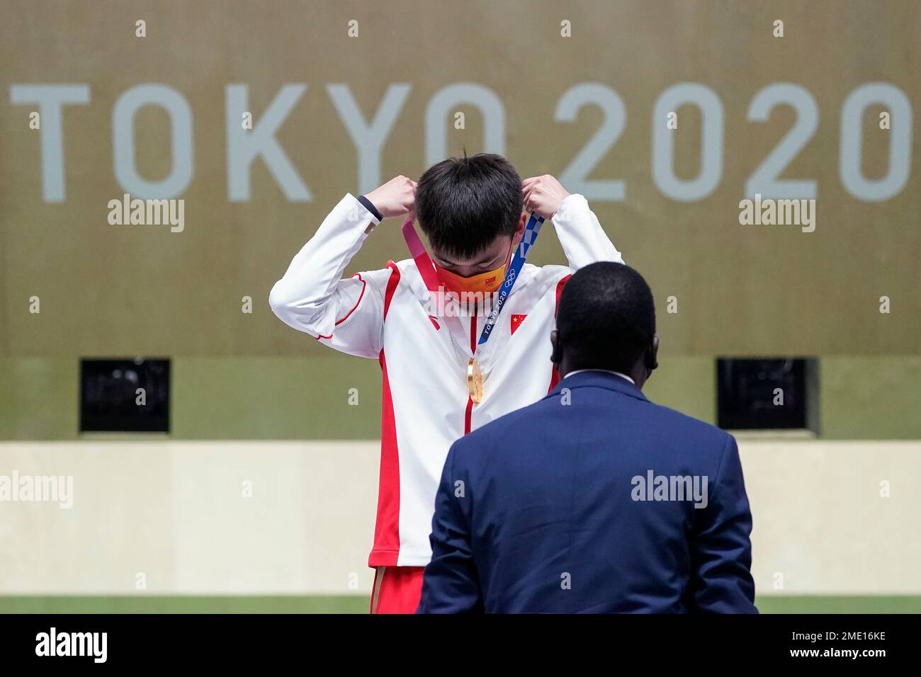 Zhang Changhong, of China, places the gold medal over his head after