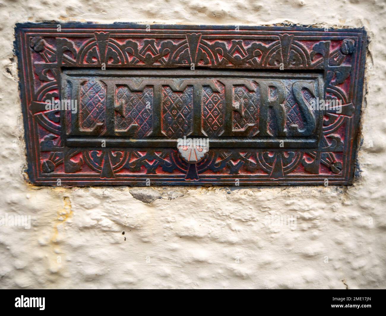 Historical style door furniture, letterbox with decorated border and embossed letters on the flap Stock Photo