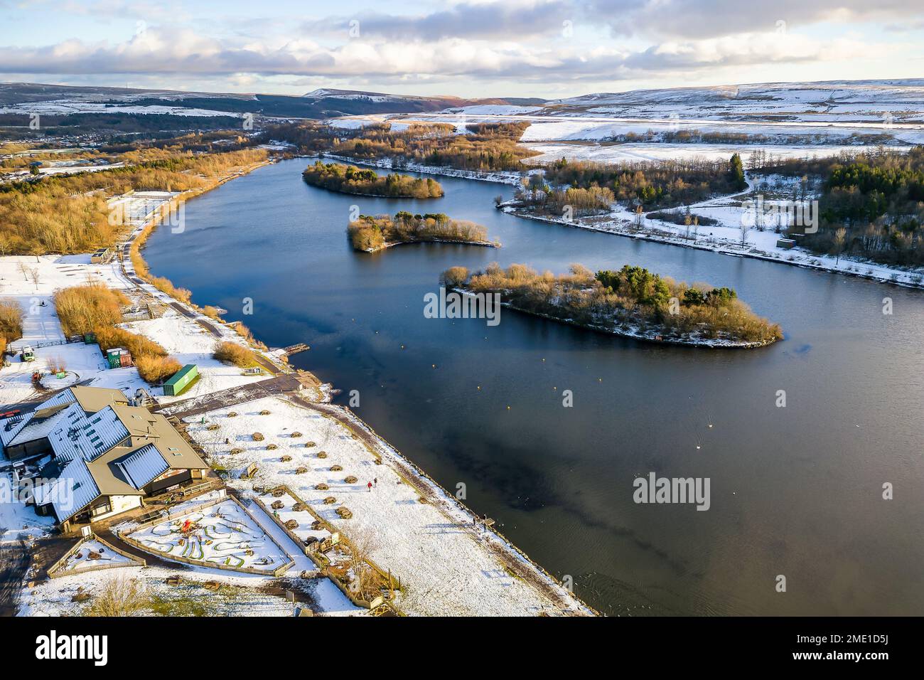 Aerial view of a freezing lake surrounded by snow in the South Wales Valleys (Bryn Bach) Stock Photo