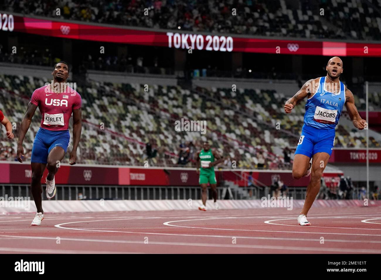 Lamont Jacobs, right, of Italy, celebrates after winning the men's the