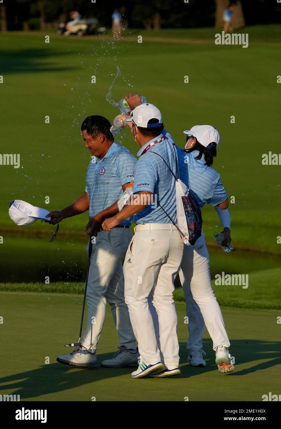 Cheng Pan of Taiwan is congratulated by his teammates after winning the bronze  medal during the final round of the men's golf event at the 2020 Summer  Olympics on Sunday, Aug. 1,