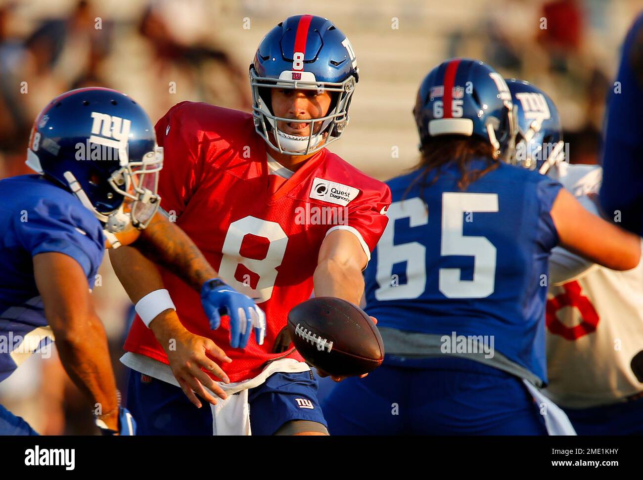 Quarterback Daniel Jones hands the ball off to running back Devontae Booker  during New York Giants NFL training camp held at Eddie Moraes Stadium,  Saturday, July 31, 2021, in Newark, N.J. (AP