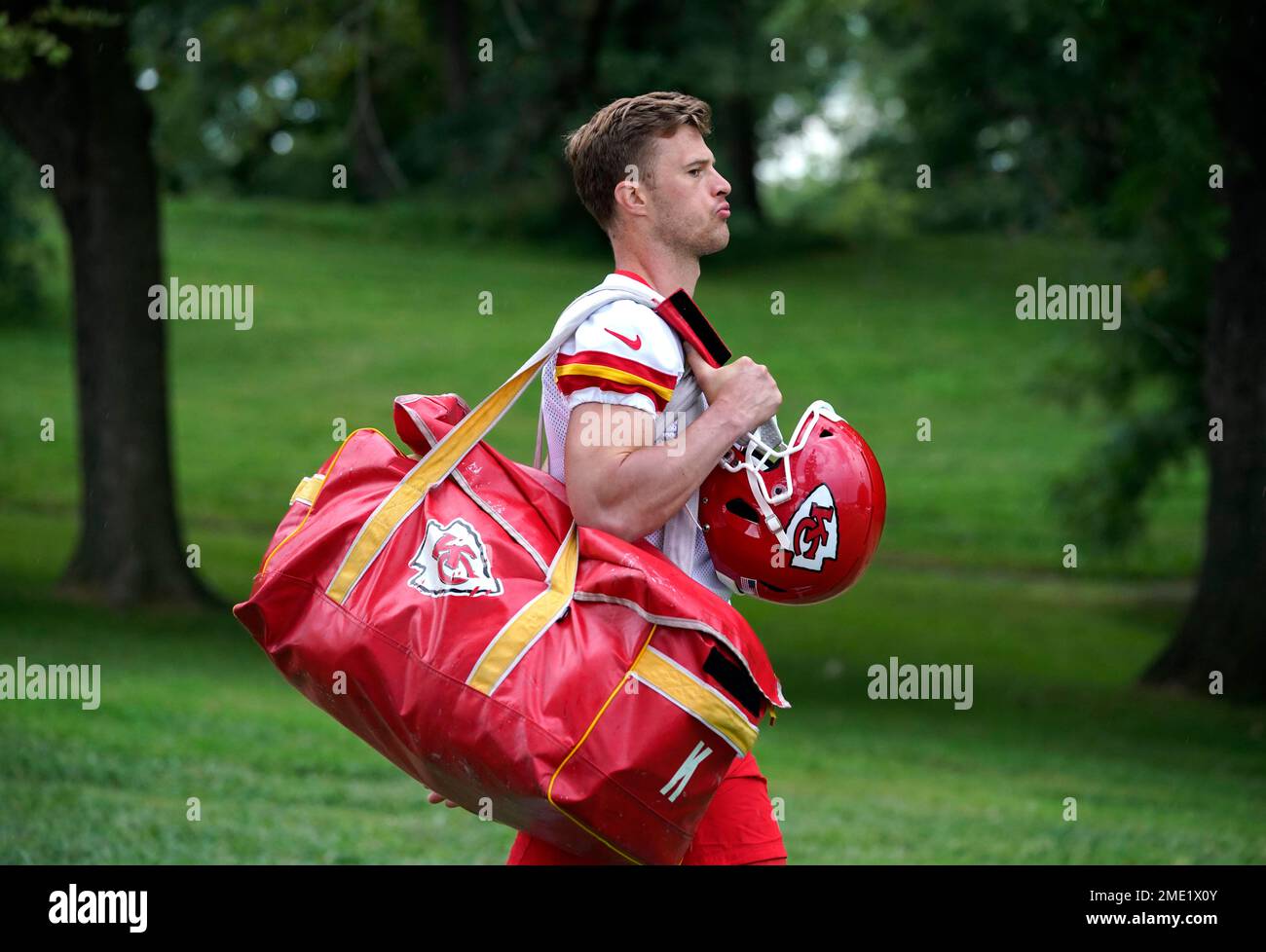 Kansas City Chiefs kicker Harrison Butker carries his equipment to the