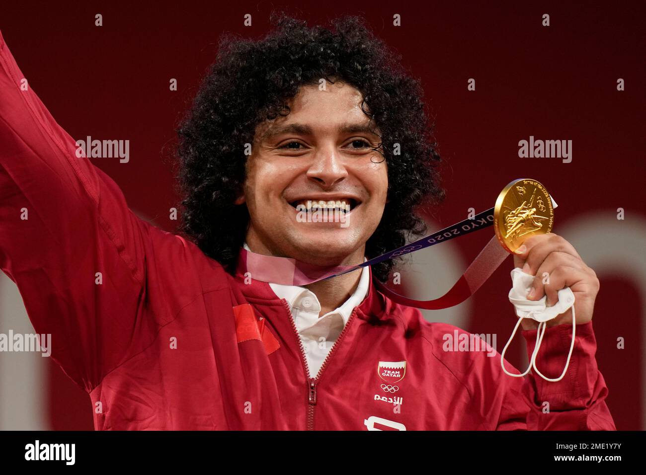 CORRECTS LAST NAME TO ELBAKH FROM ELBACH - Fares Elbakh of Qatar celebrates on the podium after winning the gold medal in the men's 81kg weightlifting event, at the 2020 Summer Olympics, Saturday, July 31, 2021, in Tokyo, Japan. (AP Photo/Luca Bruno) Stock Photo