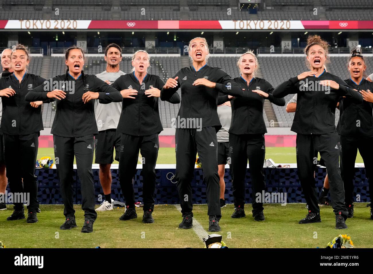 New Zealand players and team staff perform the haka after winning gold