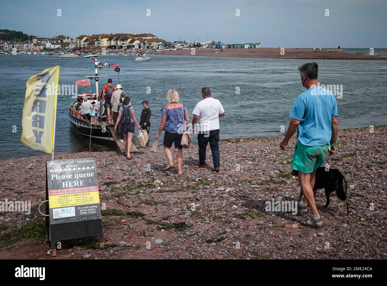 People board the TeignmouthShaldon ferry after it arrived on the beach
