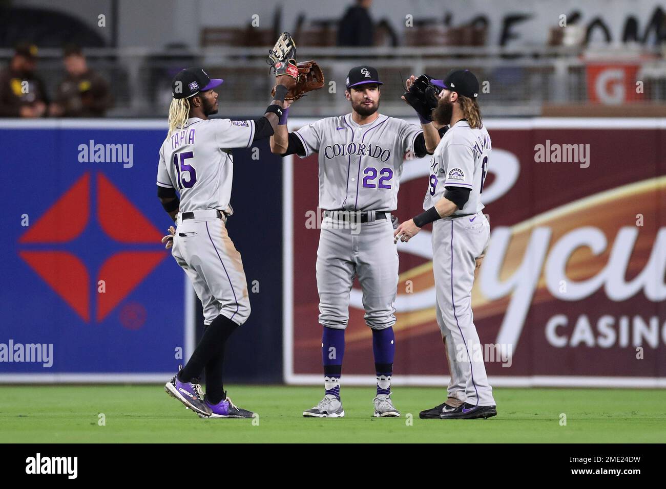 Colorado Rockies outfielders Raimel Tapia, left, Sam Hilliard (22) and