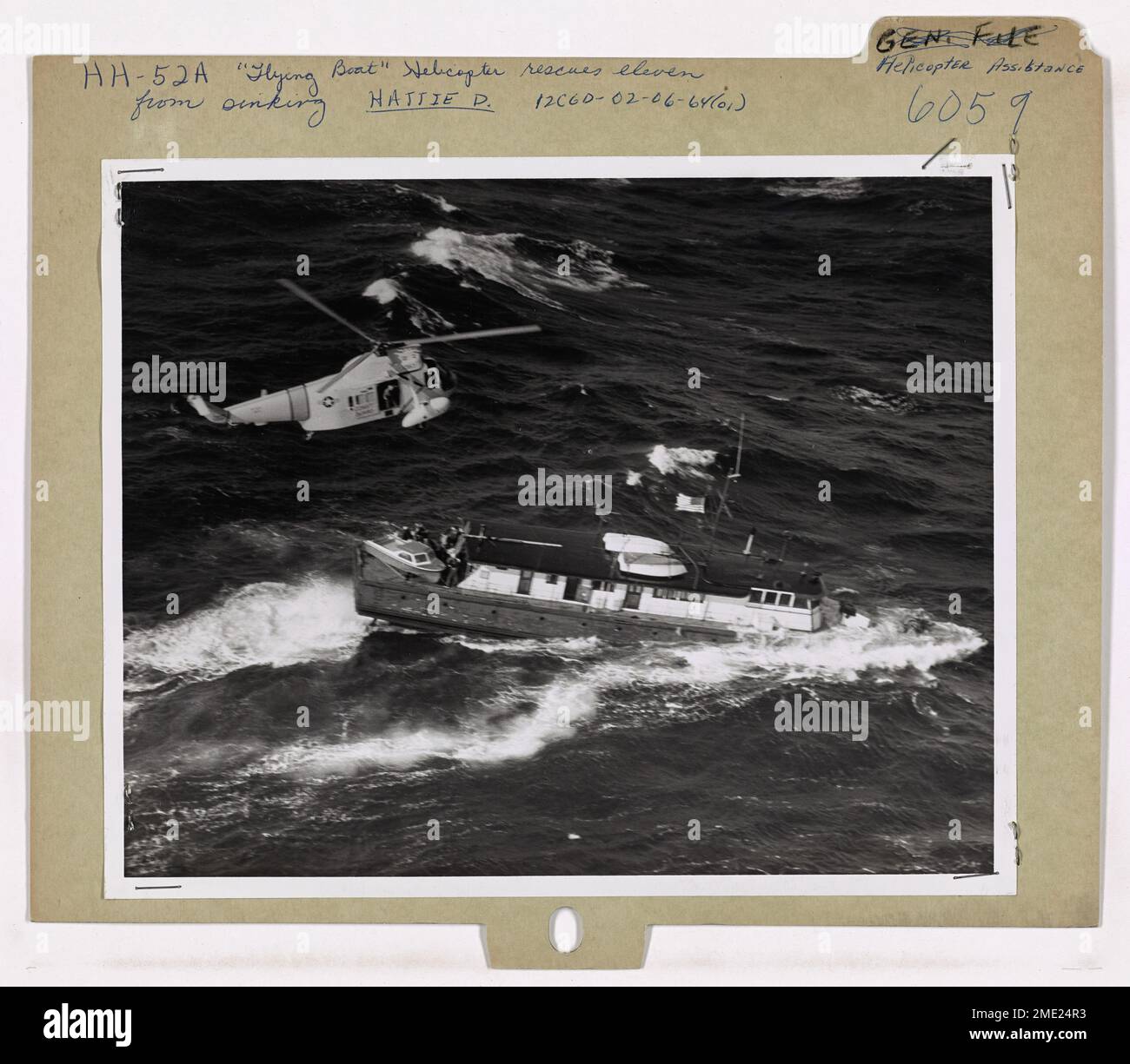 A U.S. Coast Guard flying boat helicopter rescues 11 individuals from a ...