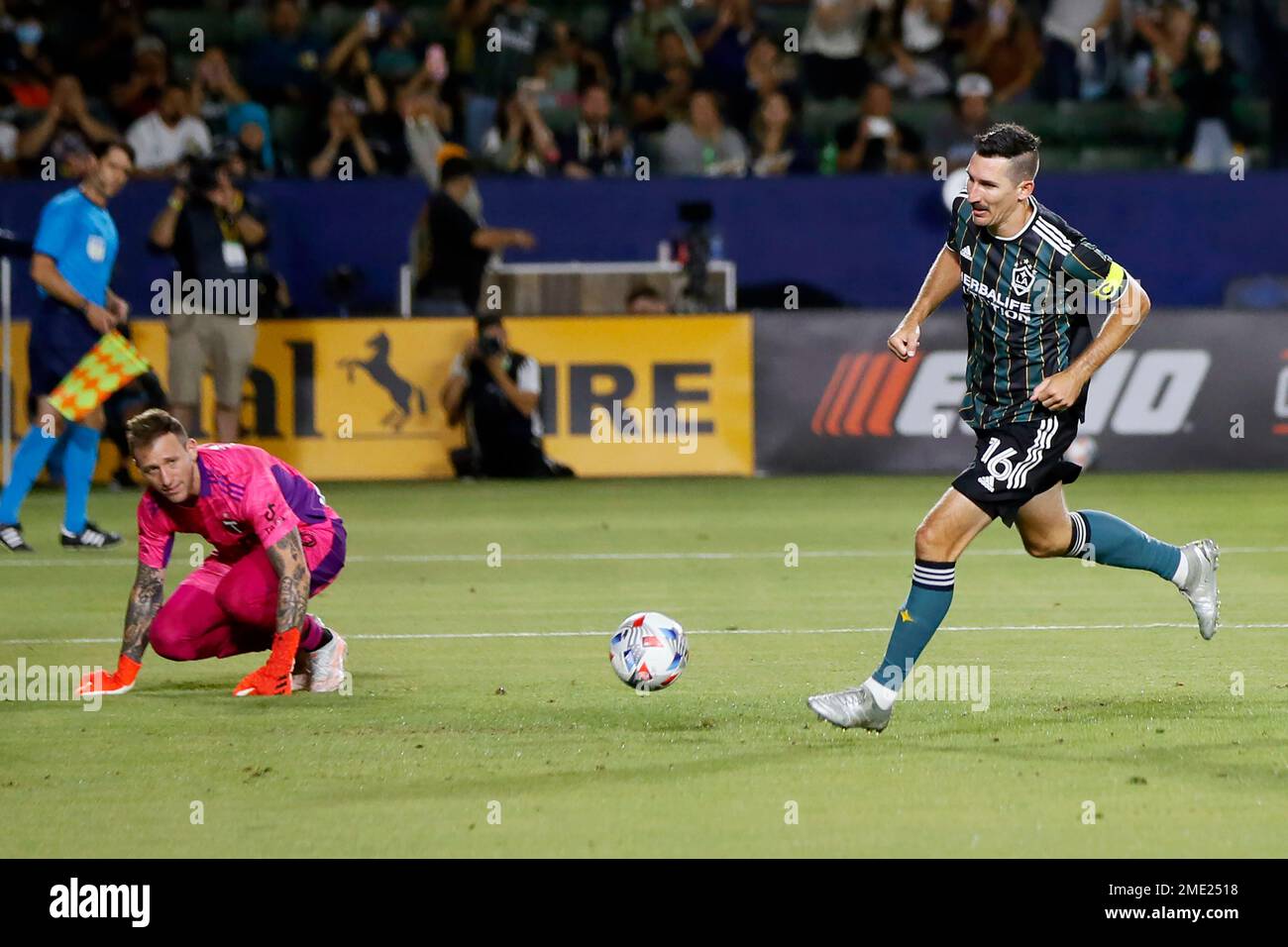 LA Galaxy midfielder Sacha Kljestan, right, runs past Portland Timbers