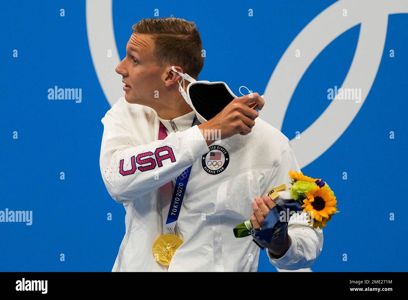 Caeleb Dressel, of United States, removes his mask to pose after ...