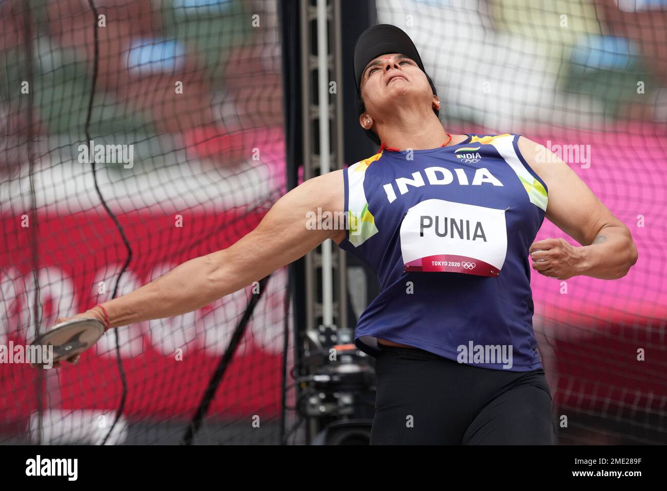Seema Punia, of India, competes in the qualification round of the women