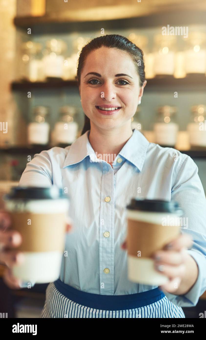 We only serve the freshest. Portrait of a young barista holding cups of