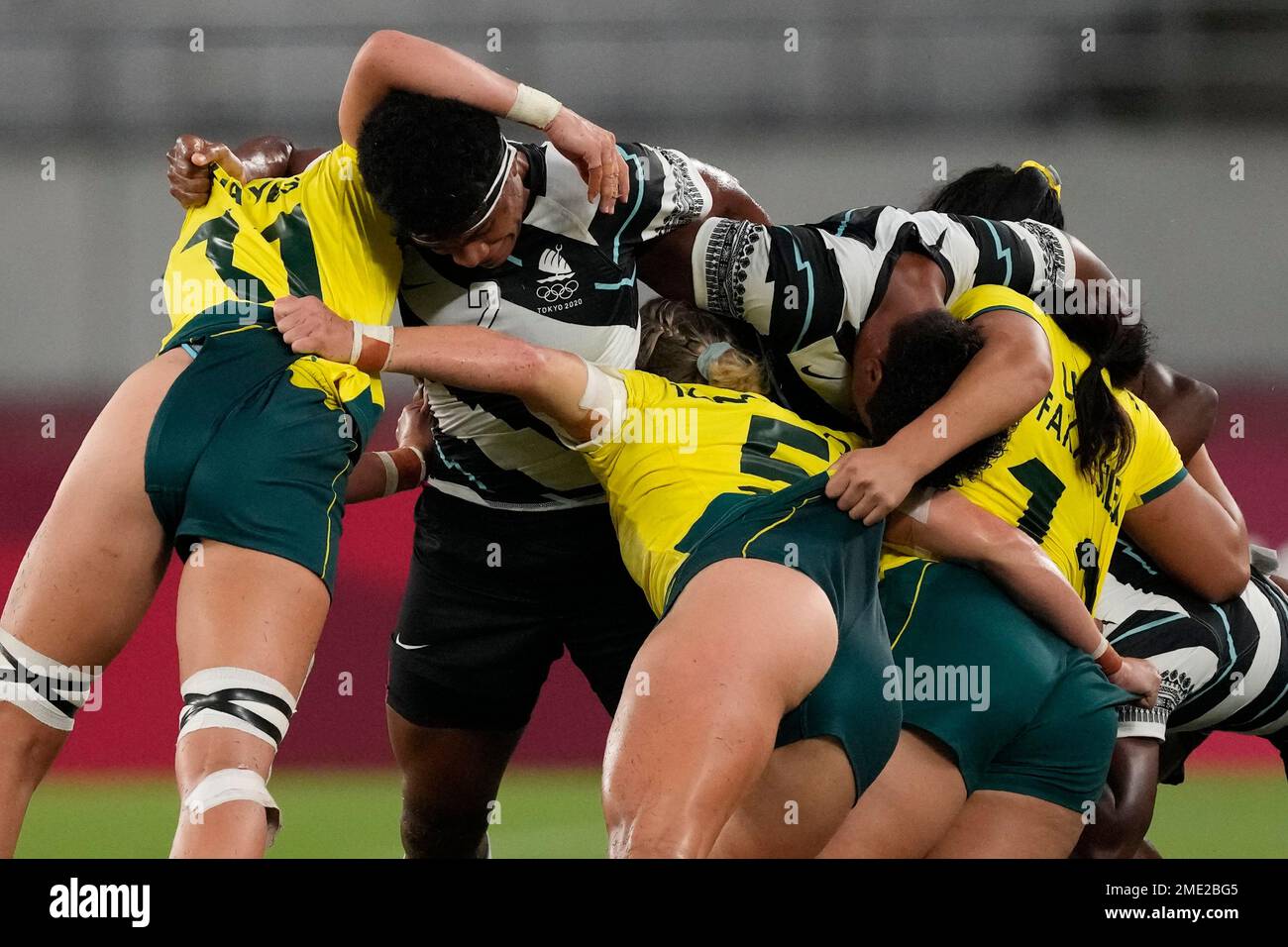 Australia and Fiji players wrangle in a scrum, during their women's