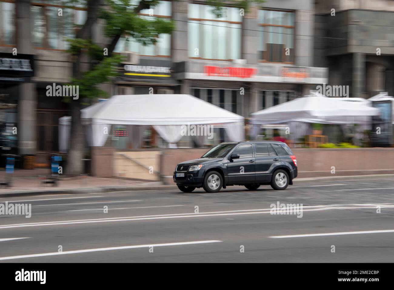 Ukraine, Kyiv - 2 August 2021: Gray Suzuki Grand Vitara car moving on the street. Editorial Stock Photo