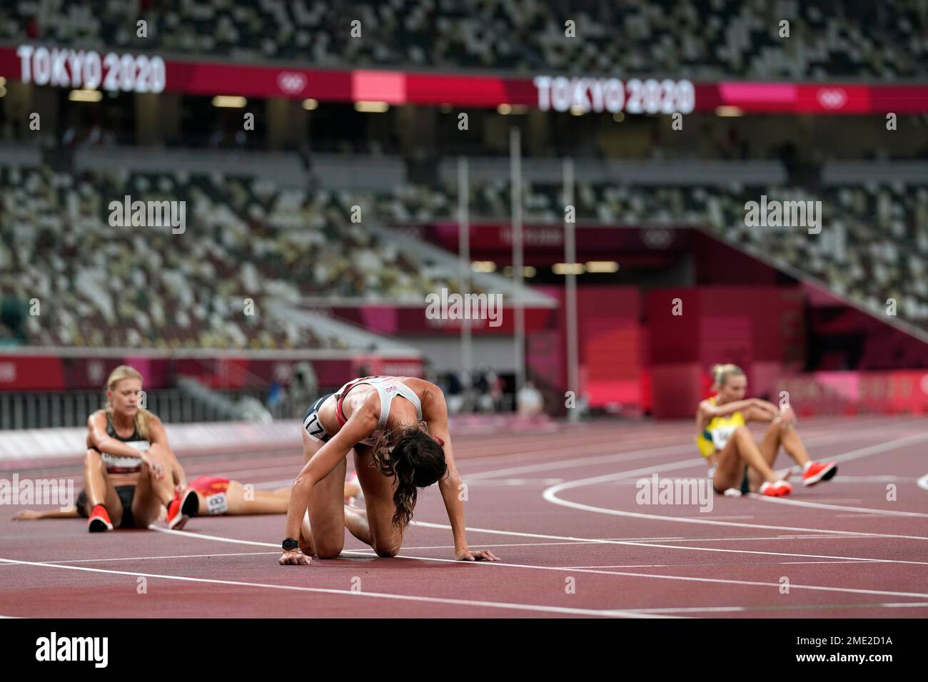 Runners collapse after a heat in the women's 5,000-meter run at the ...