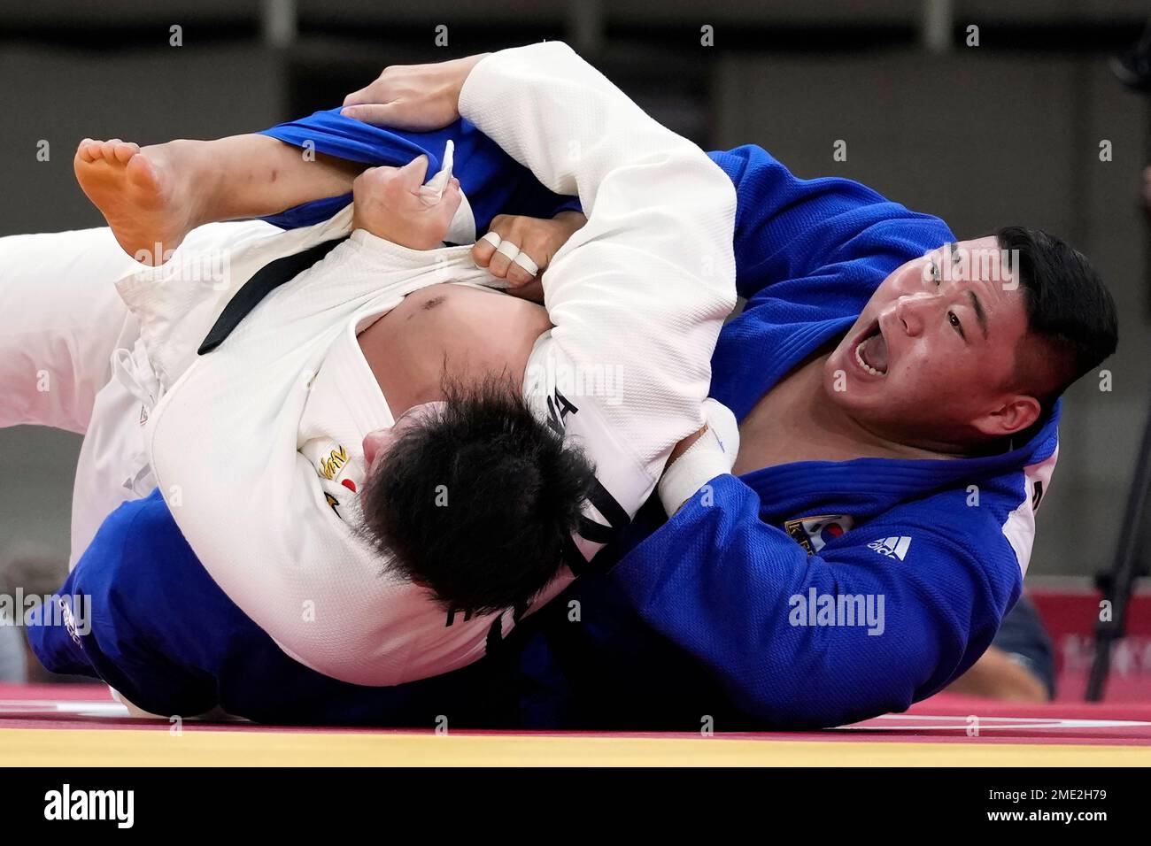 Kim Minjong of South Korea, right, and Hisayoshi Harasawa of Japan compete during their mens +100kg elimination round judo match at the 2020 Summer Olympics, Friday, July 30, 2021, in Tokyo, Japan