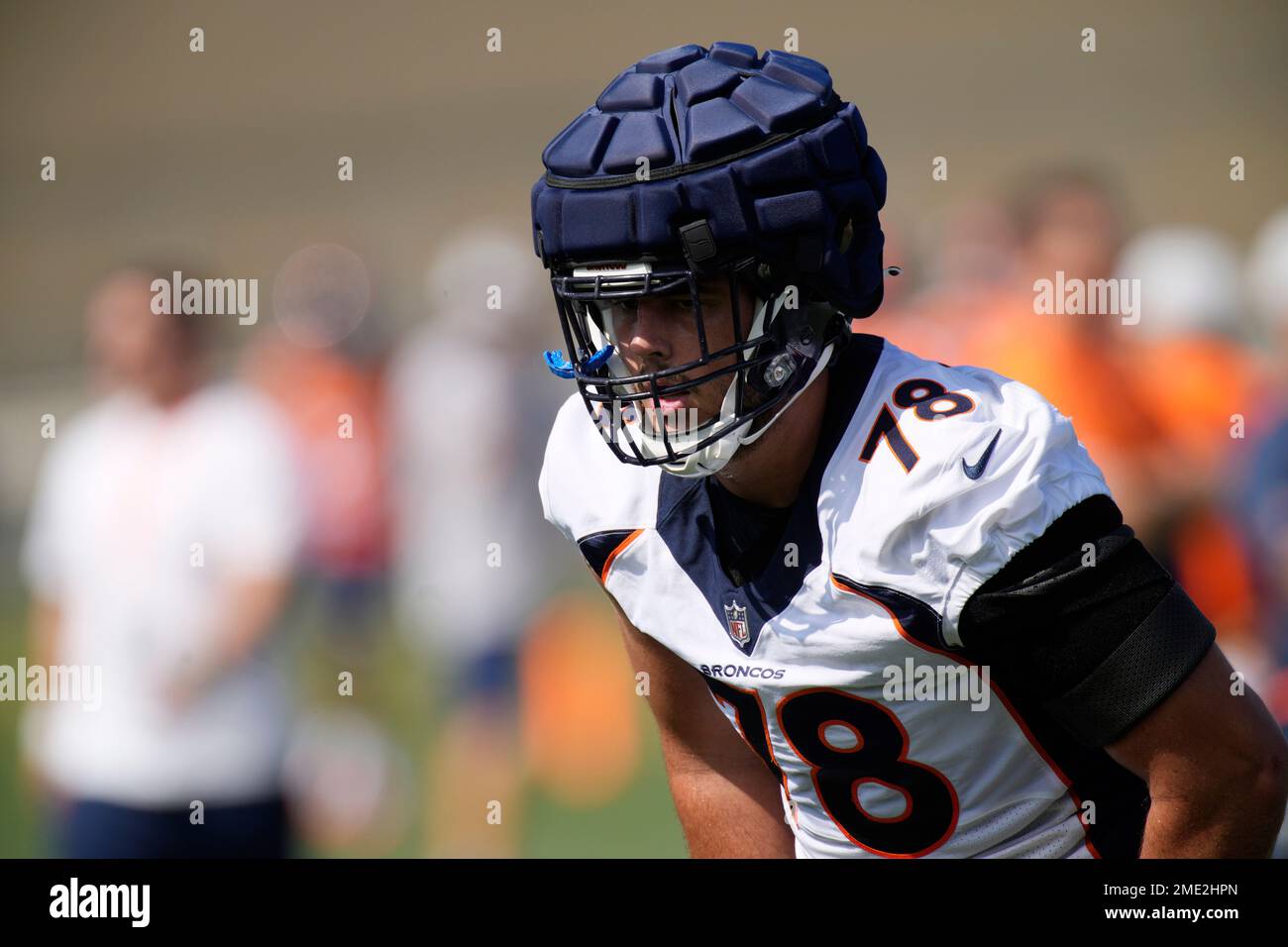 Denver Broncos' Drew Himmelman (78), Adrian Killins (17), Mac McCain III  (49), Dre'Mont Jones (93), K.J. Hamler (1) and other players walk on the  field during warm ups before an NFL football