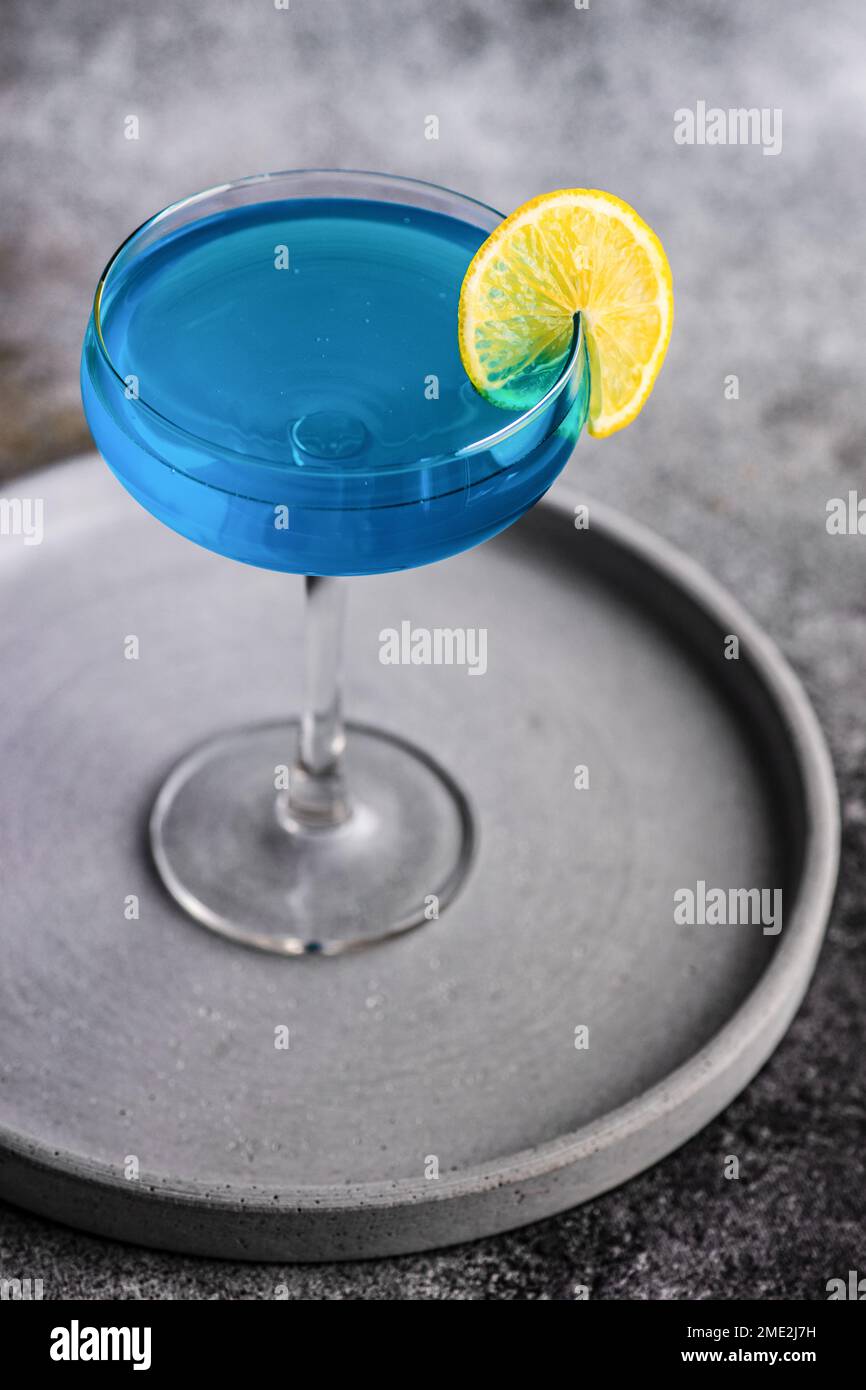 Glass of blue kamikaze drink on stone table in modern style Stock Photo ...