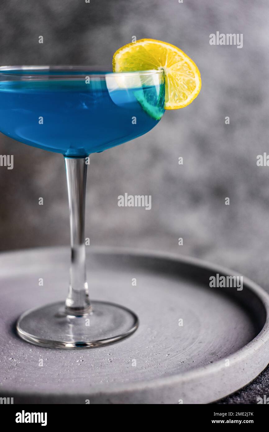 Glass of blue kamikaze drink on stone table in modern style Stock Photo ...