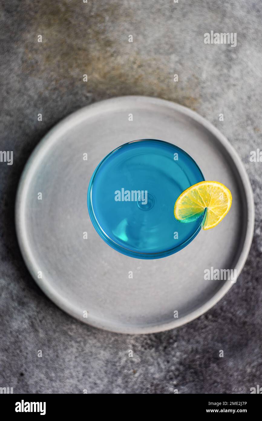 Glass of blue kamikaze drink on stone table in modern style Stock Photo ...