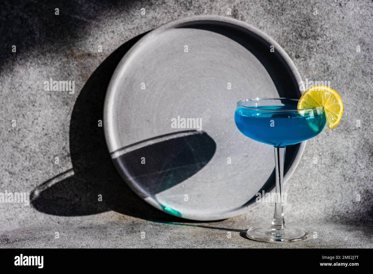 Glass of blue kamikaze drink on stone table in modern style Stock Photo ...