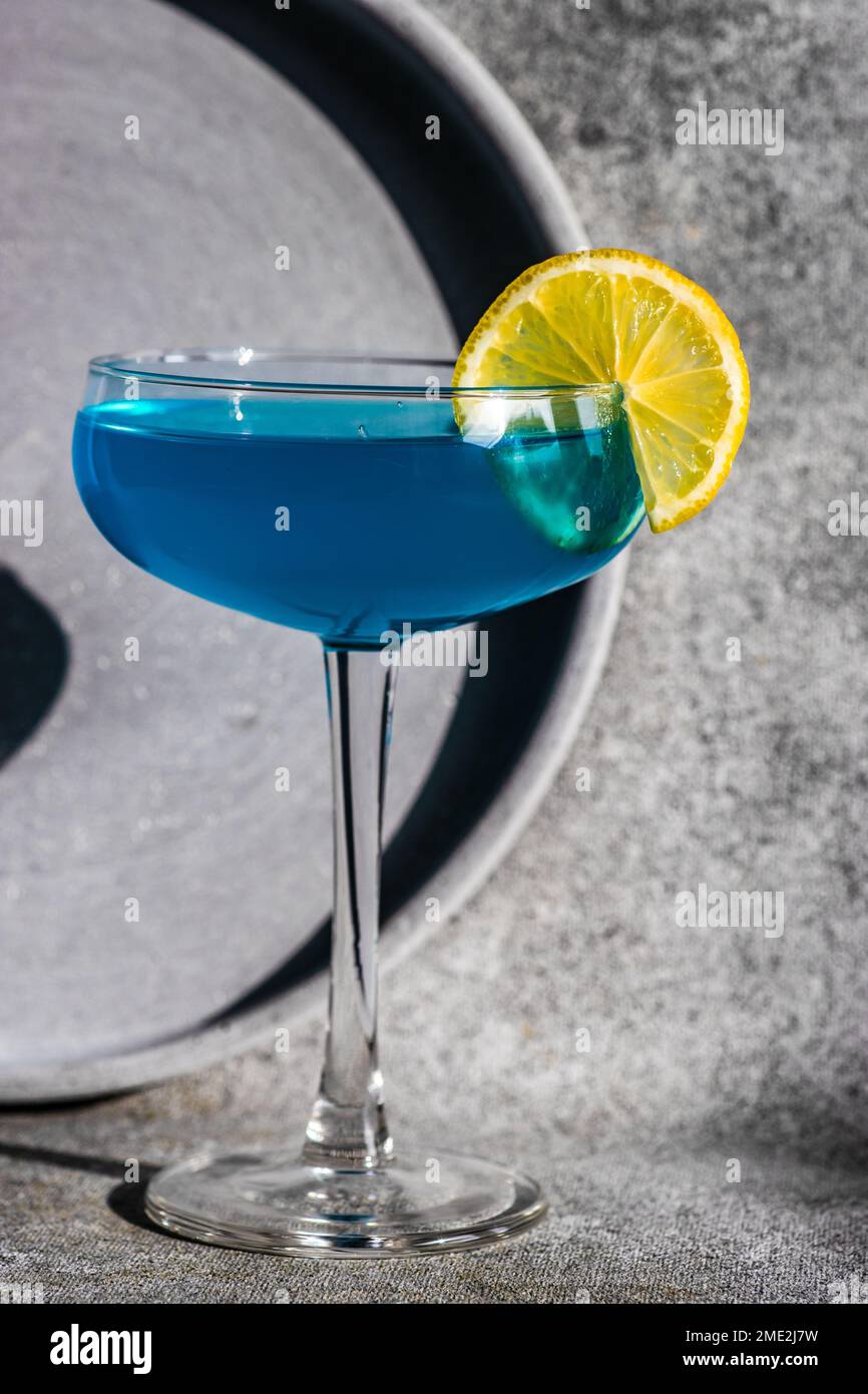 Glass of blue kamikaze drink on stone table in modern style Stock Photo ...