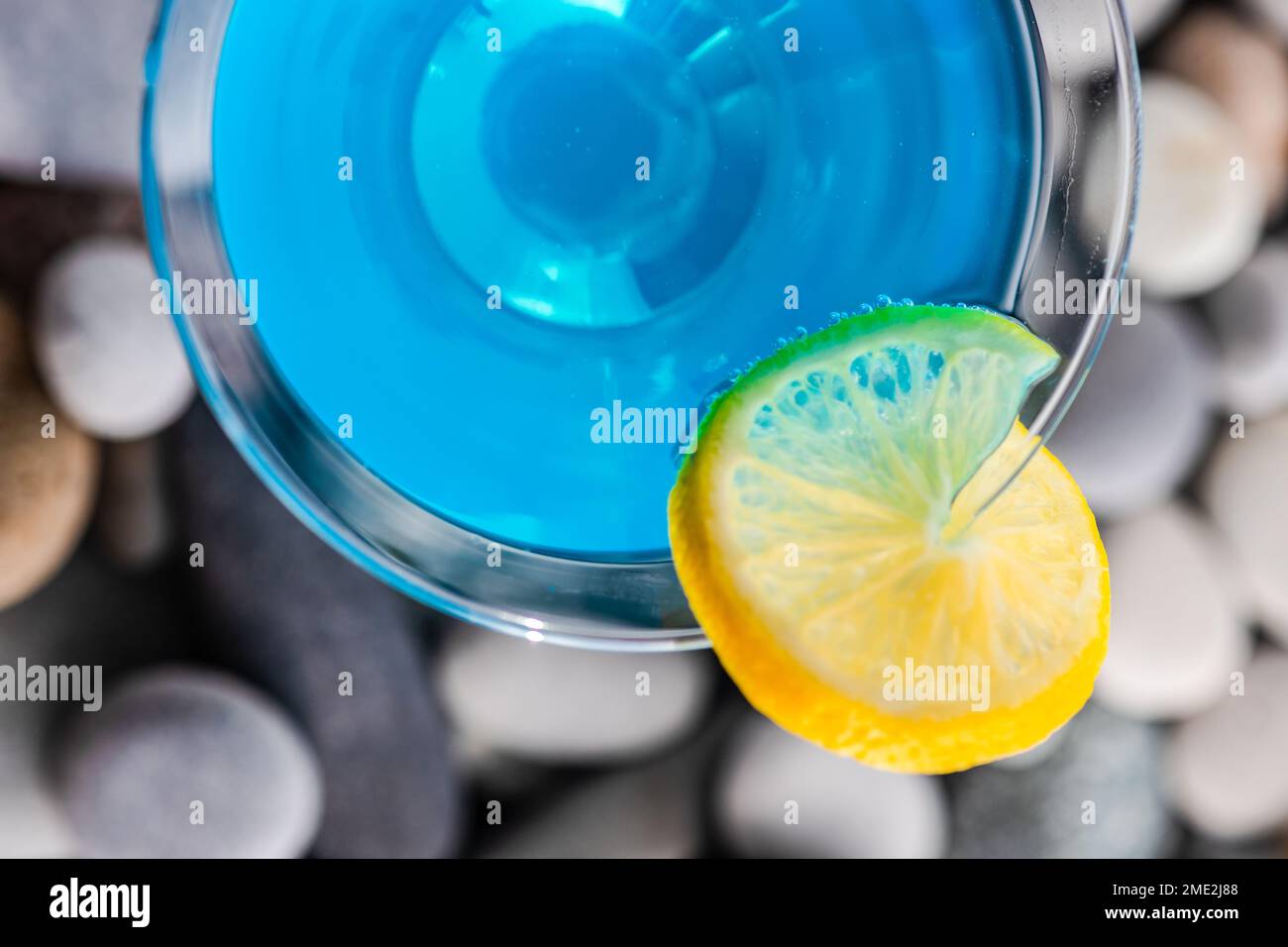 Glass of blue kamikaze drink on stones in modern style Stock Photo - Alamy