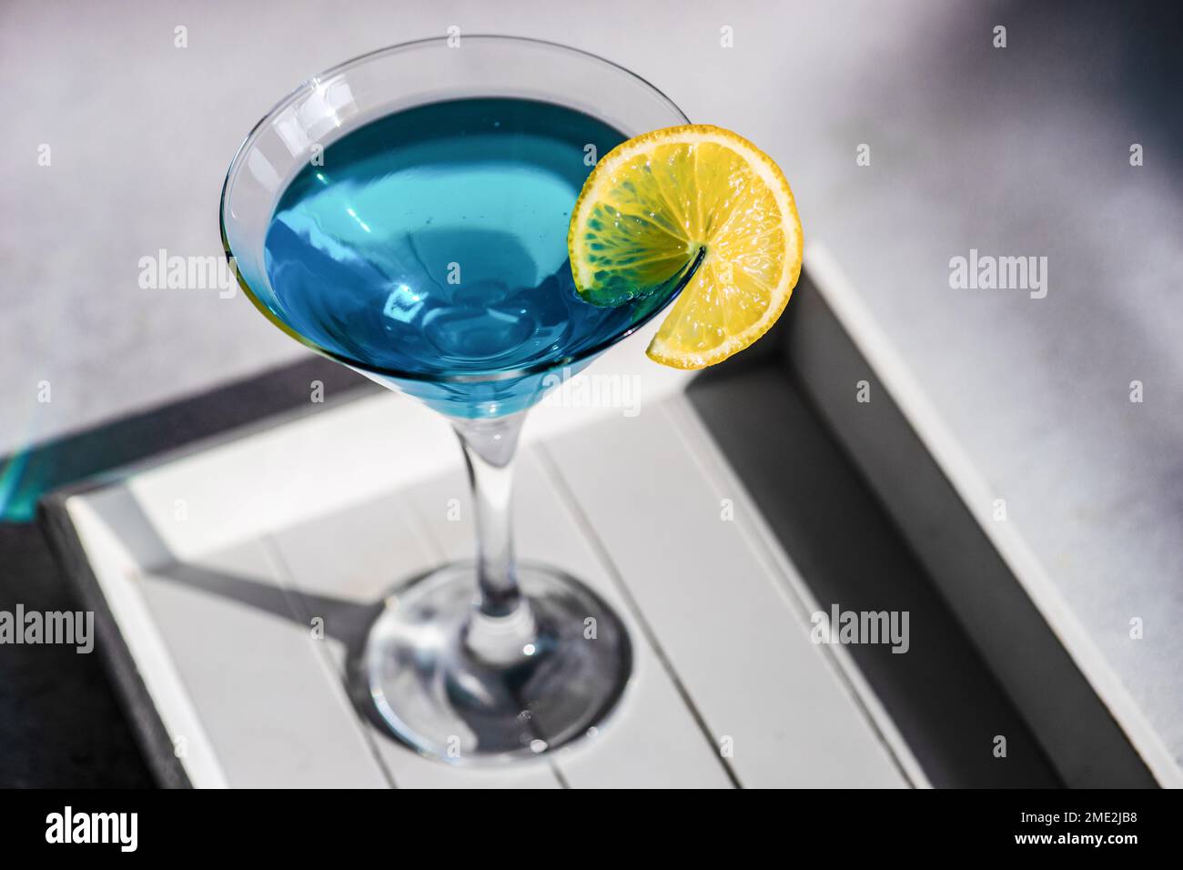 Glass of blue kamikaze drink on stone table in modern style Stock Photo ...