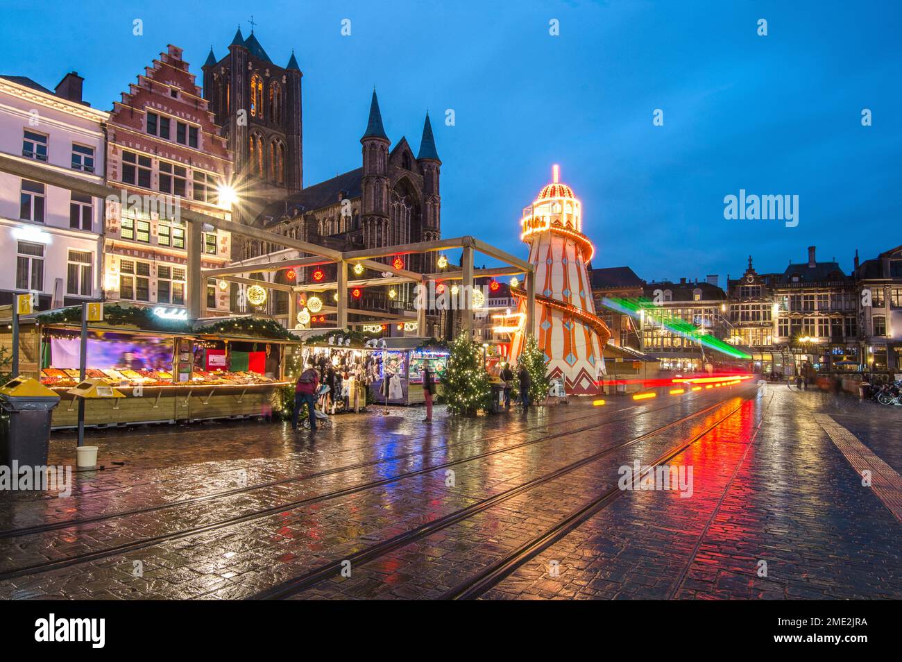 Ghent Christmas market with glowing lights in evening town near old