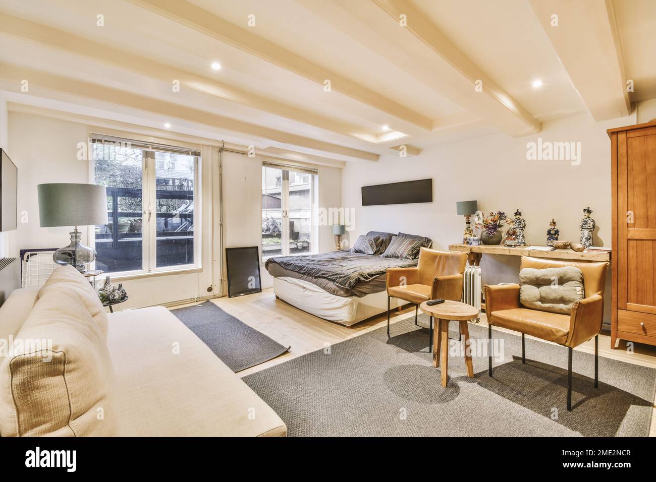 Picture of Interior design of modern open plan apartment with comfortable bed and ...