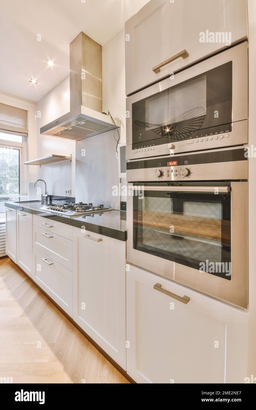 Interior design of modern kitchen with white cupboards built in ...