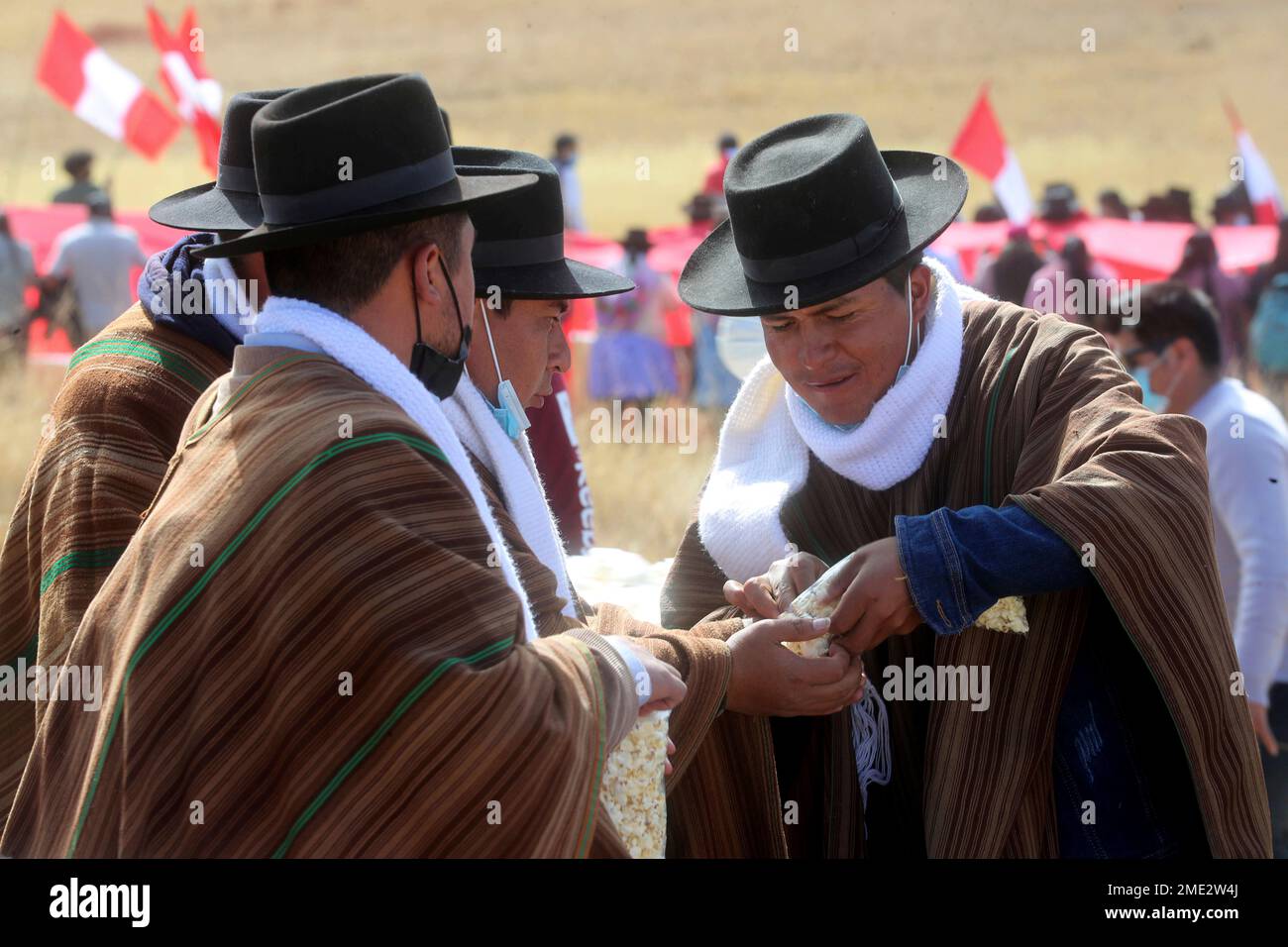 People share popcorn as they wait for Peruvian President Pedro Castillo